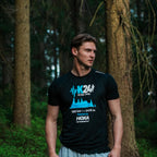 Man wearing a black t-shirt with K24 Ultra-Trail branding in a forest setting