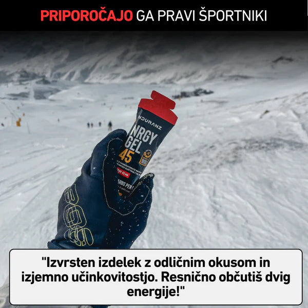 Hand holding an energy gel in a snowy landscape with text overlay.