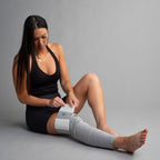 Woman applying gray bandage tape on a gray background