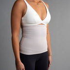 Person wearing a white compression garment against a gray background