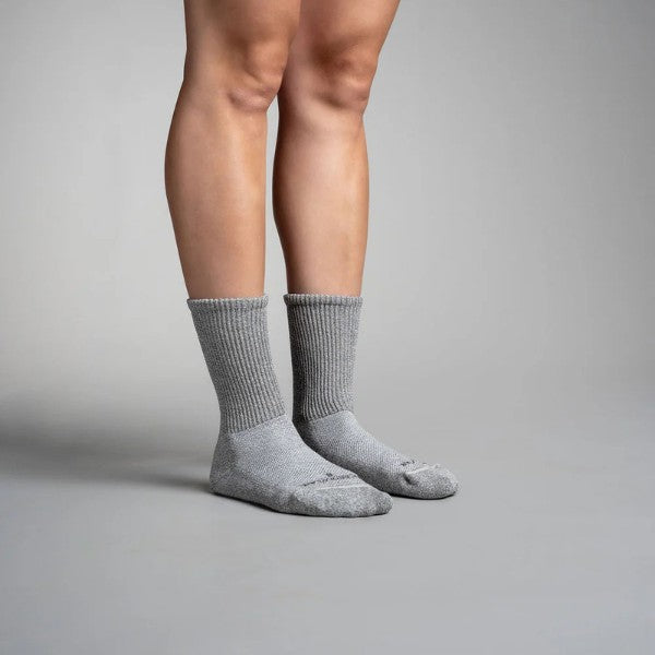 Gray circulation crew socks worn by a person on a gray background