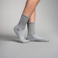 Gray circulation crew socks worn by a person on a gray background