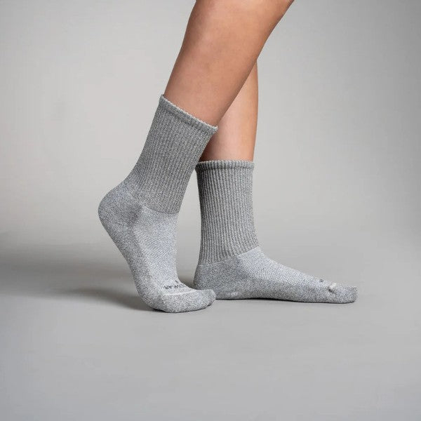 Gray circulation crew socks worn by a person on a gray background