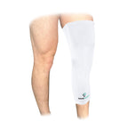White leg sleeve on a person's knee with a visible brand logo.