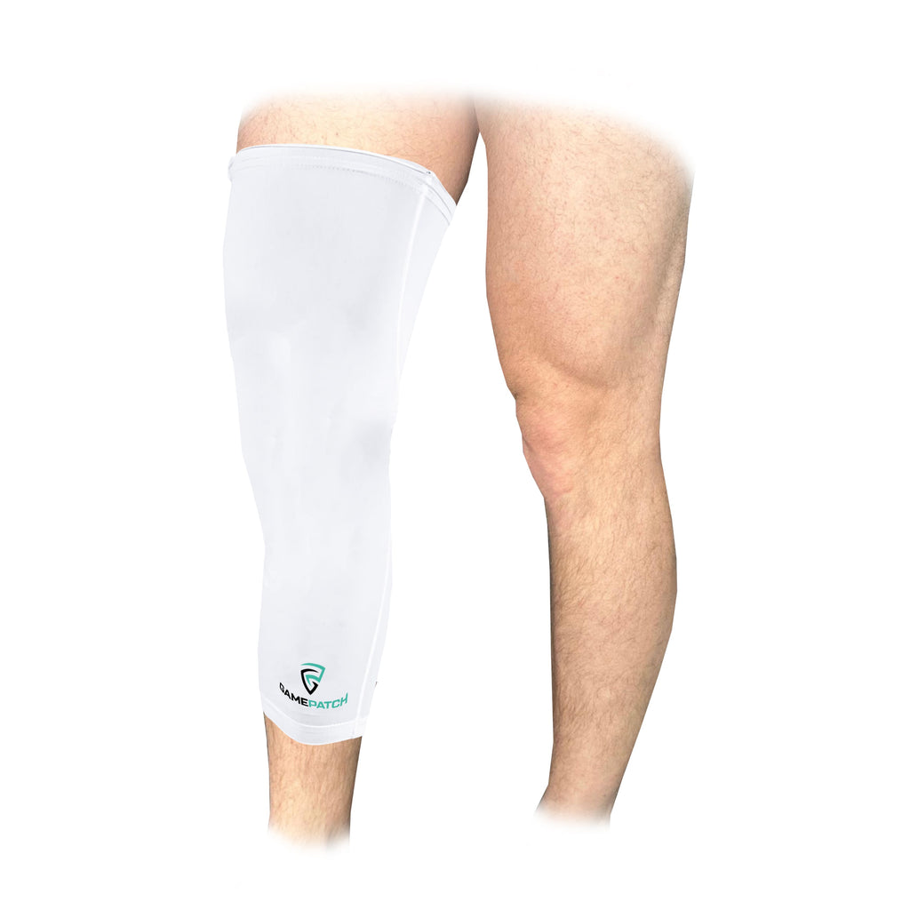 White leg sleeve on a person's knee with a visible brand logo against a white background