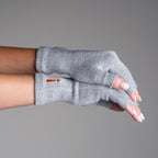 Gray fingerless gloves worn on a neutral background