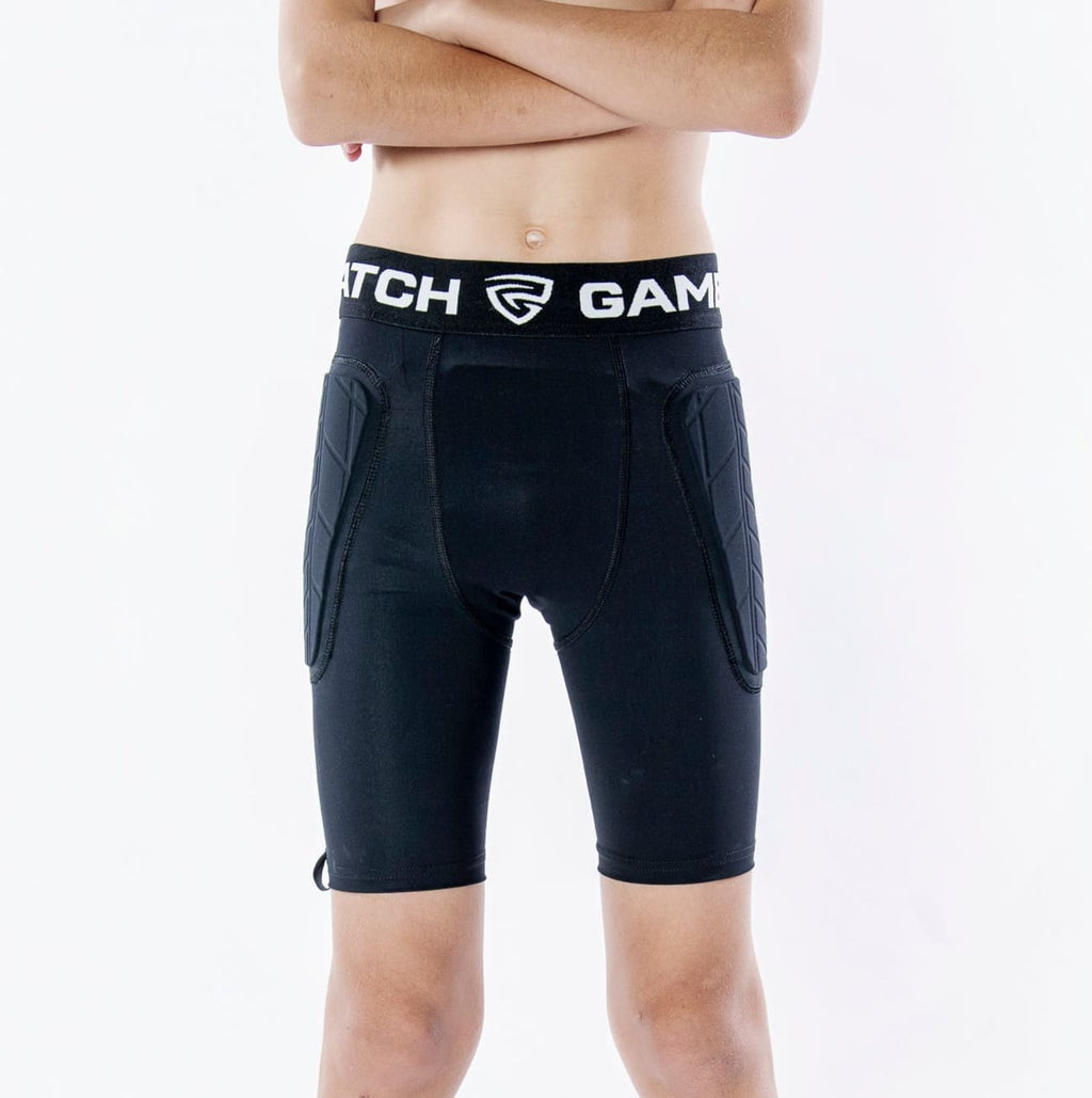 Person wearing black athletic shorts with a visible brand logo on a white background