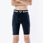 Person wearing black athletic shorts with a visible brand logo on a white background