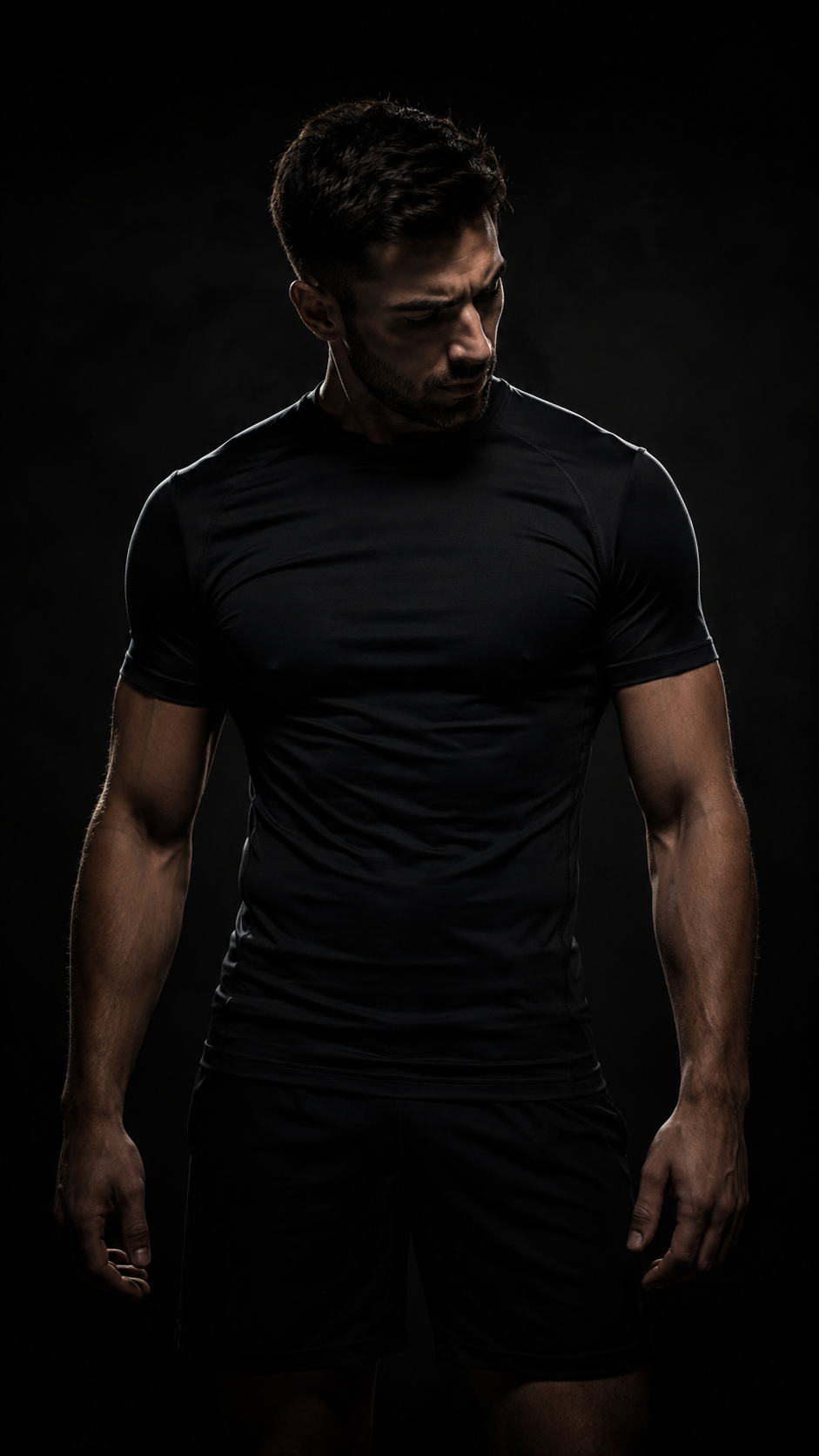 man werring black GamePatch shirt on a black background