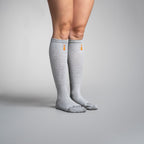 Gray knee-high socks with a brand logo on a gray background