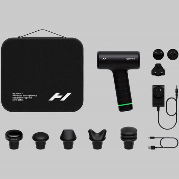 Black handheld device with attachments and carrying case on a gray background