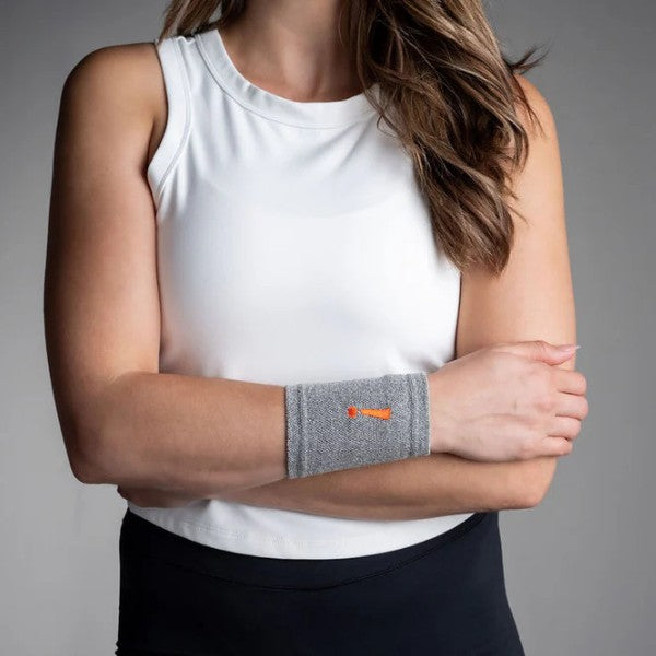 a womean wearing wrist sleeve grey front on body incrediwear