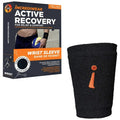 Black wrist sleeve with orange logo next to its packaging on a white background